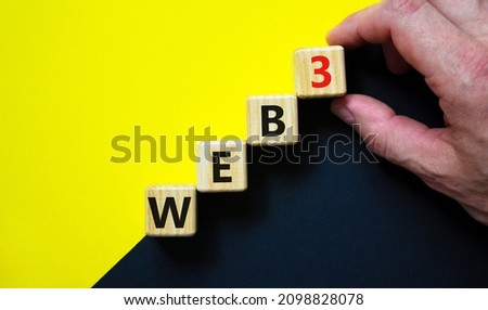 WEB3 or web 3 symbol. Wooden cubes with concept words WEB 3. Beautiful yellow and black background, copy space. Businessman hand. Business, technology web3 and WEB 3 or 3.0 concept.
