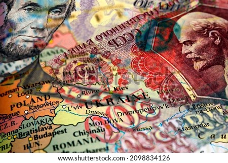 Close up of a 5 US dollar bill and Russian ruble banknote on top of a map of Ukraine Royalty-Free Stock Photo #2098834126