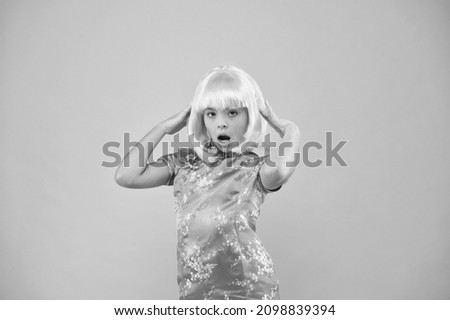 Girl yellow wig. Cosplay character concept. Japanese style. Eastern trends for teens. Hobby and entertainment. Pop culture. Anime fan. Child cute cosplayer. Anime emotional expression. Anime admirer