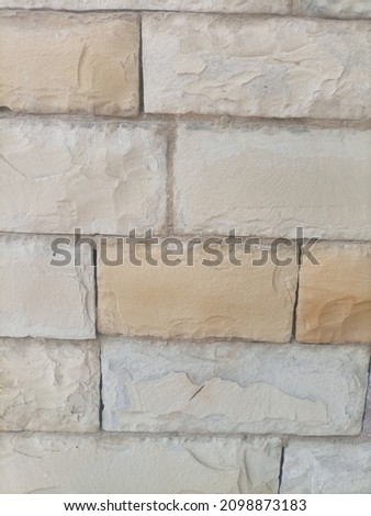 Yellow textured tiles on a wall