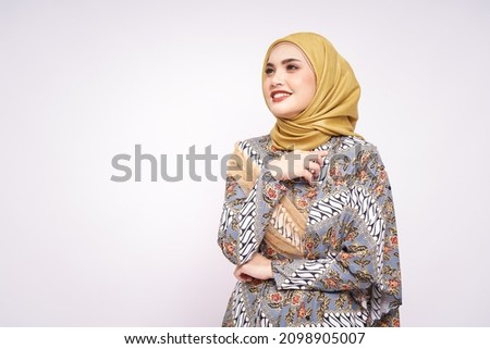 Beautiful female model wearing modern batik kebaya with hijab, an Asian traditional dress for Muslim woman isolated over white background. Stylish Muslim female fashion lifestyle  concept. Royalty-Free Stock Photo #2098905007
