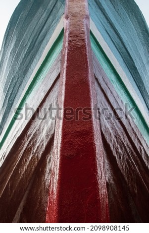 The vertical line of a wooden ship a combination of green white and red