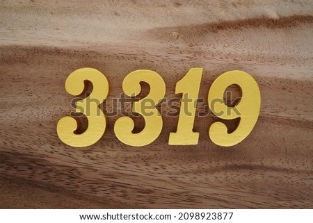 Golden Arabic numerals 3319 on a dark brown to white wood grain background.