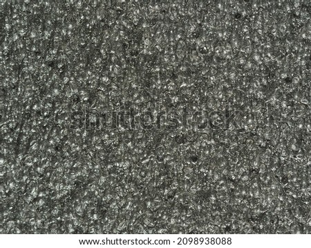 close up, background, texture, large horizontal banner. surface structure black expanded polyethylene, EPE, padding cushioning material for packages. full depth of field. high resolution photo