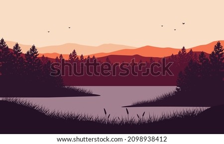 Stunning mountain view with dry tree sunrise from the lakeside at dusk in the afternoon
