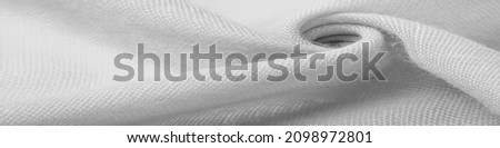 Silk fabric in white. Grunge surface texture with fine grains, dots, abstract background. Monochrome background from thin material. Overlay template