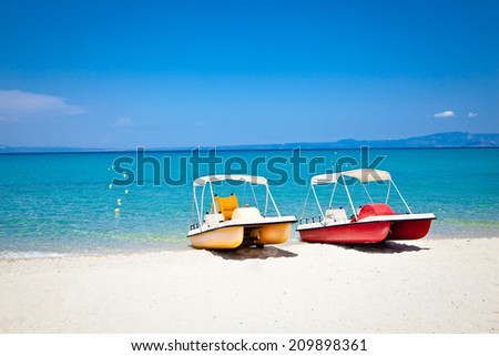 Beautiful Hanioti beach with Colorful pedalos docked on Kasandra peninsula, Halkidiki,  Greece. Royalty-Free Stock Photo #209898361
