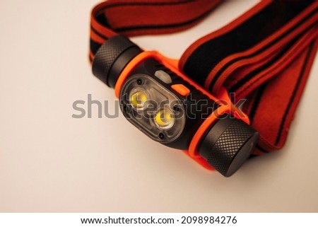 modern LED powerful rechargeable headlamp with adjustable strap Royalty-Free Stock Photo #2098984276