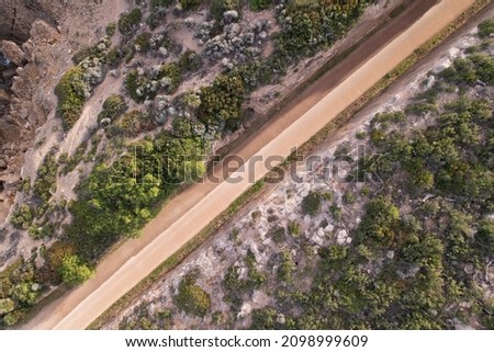 Diagonal Top view of an unasphalted road carved on the mountain