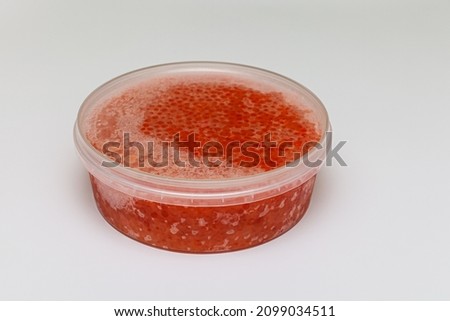closed plastic jar with natural frozen caviar. High quality photo