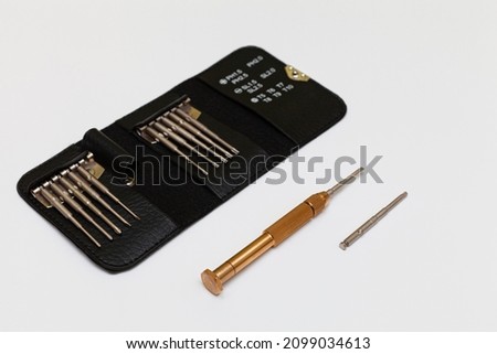 a set of small screwdrivers with a removable handle on a white background. High quality photo