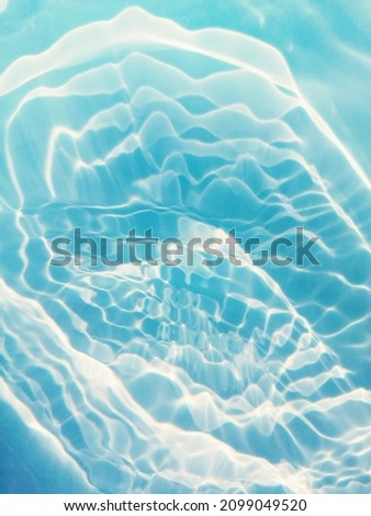 Closeup​ blur​ abstract​ of​ surface​ blue​ water. Abstract​ of​ surface​ blue​ water​ reflected​ with​ sunlight​ for​ background.Top​ view​ of blue​ water for​ background​.​
