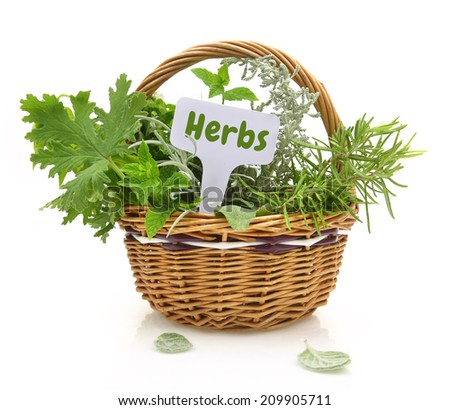 Fresh herbs in wicker basket with a tag