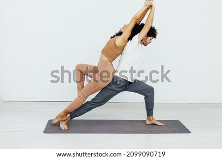 Man and woman doing exercises yoga asana fitness