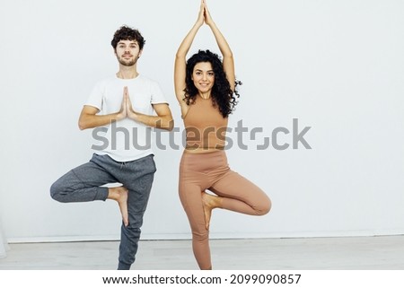 Man and woman doing exercises yoga asana fitness