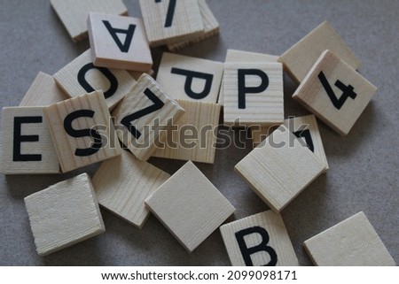Pile of wooden tiles with letters on