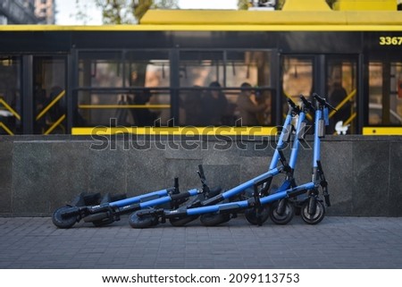 knocked off and lying of rent service kick scooters on street sidewalk Royalty-Free Stock Photo #2099113753