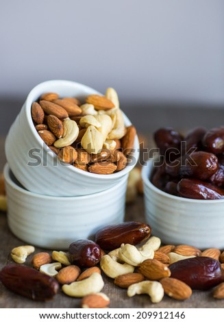 An assortment of healthy nuts in a bowl : almond, cashew, dates and hazelnut, making a healthy snack alternative