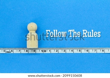 peg doll on the measuring line with the words follow the rules