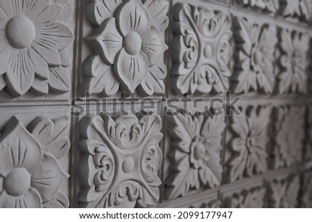 Detailed portrait of the wall with many carvings.