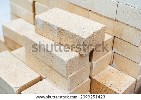 A stack of white bricks. Building materials in a warehouse of a wholesale store. Close-up