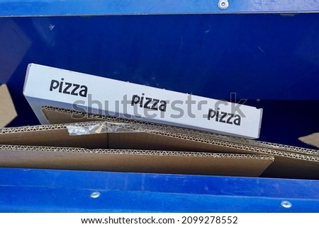                               Pizza cartons. Cardboards with the word pizza in a blue cardboard container. Recycling