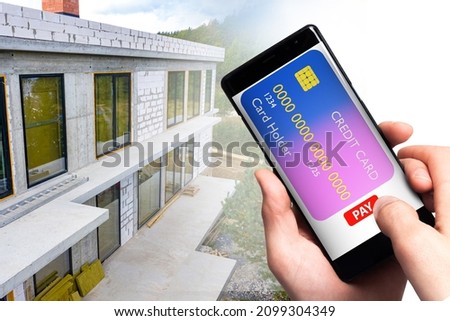 Construction payments. Applications for hiring construction crew. Concept of online payment for architect services. Two-storey house under construction. Phone from bank card for payments