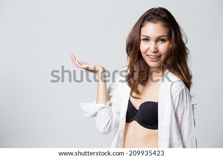 Beautiful brunette girl in white shirt smiling on white background