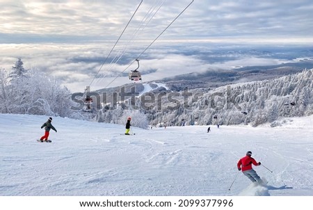 Mont and Tremblant Lake in winter with skiers on the foreground, Quebec, Canada Royalty-Free Stock Photo #2099377996
