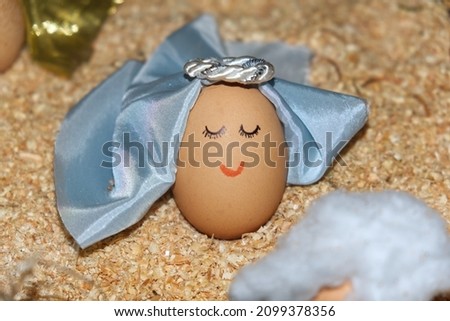 funny anthropized egg with angel face and virgin veil