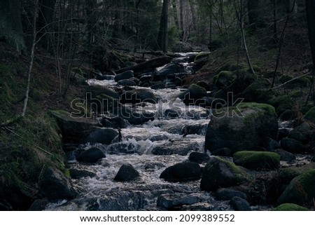 rocky seashore with flowing water in the evening