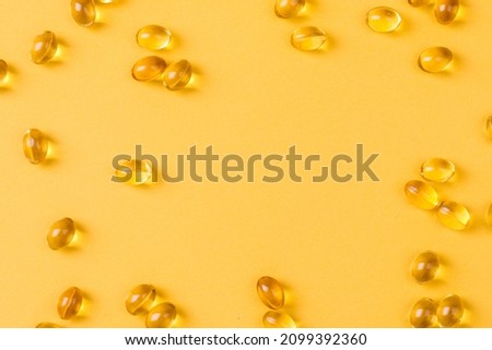 Close up of  oil filled capsules suitable for: fish oil, omega 3, omega 6, omega 9,  vitamin A, vitamin D, vitamin D3, vitamin E  Royalty-Free Stock Photo #2099392360