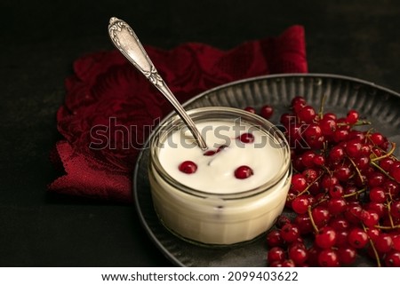 Gooseberry cottage cheese in a bowl on a platter on a dark background
