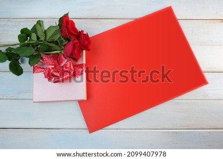bouquet of red roses, box with gift with satin ribbon, empty form, card for congratulations, flowers for professional holiday, concept of mother's, Valentine's day, birthday, selective focus
