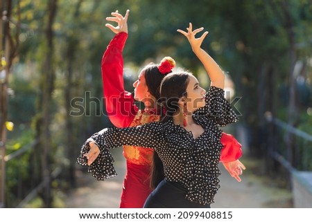 Pair of female flamenco dancers performing a choreography outdoors Royalty-Free Stock Photo #2099408815