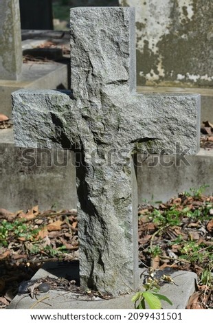 Stone cross as a headstone at a Christian cemetery