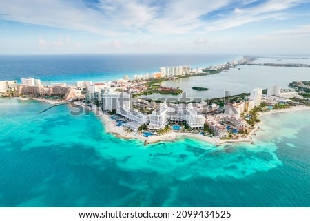 Aerial panoramic view of Cancun beach and city hotel zone in Mexico. Caribbean coast landscape of Mexican resort with beach Playa Caracol and Kukulcan road. Riviera Maya in Quintana roo region on Royalty-Free Stock Photo #2099434525
