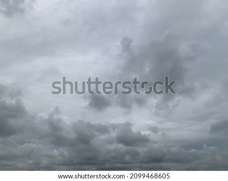 Thunder cloud, Nimbostratus Clouds A gray Style rolls are round to each other in sheets or layers and Huge scary storm it's going to rain heavily at Thailand.no focus Royalty-Free Stock Photo #2099468605