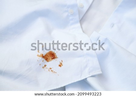 dirty barbeque sauce stain on cloth from daily life activity for cleaning concept. housework care living life of people Royalty-Free Stock Photo #2099493223
