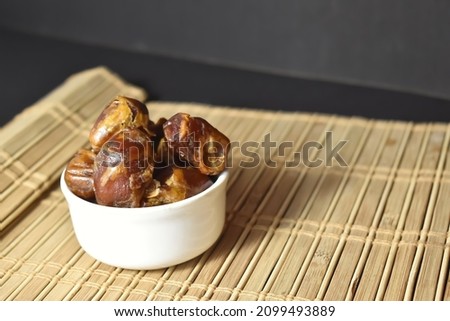 Selective focus picture of bowl full dates. Muslims eat Dry fruits as Iftar fasting in Ramzan