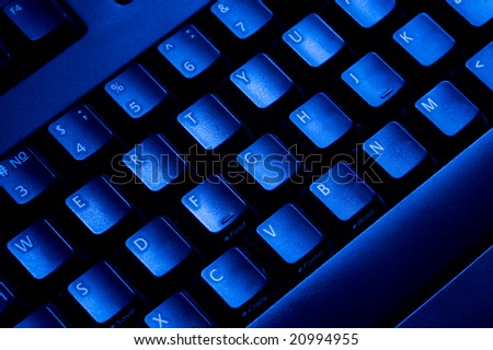 Close-up computer keyboard. Blue light