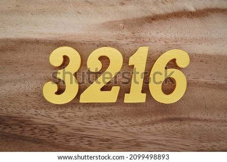 Golden Arabic numerals 3216 on a dark brown to white wood grain background.