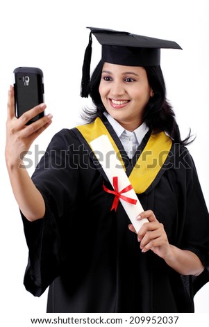 Young female graduated student taking selfie