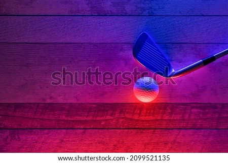 Golf stick and  white ball on hardwood court floor with neon lighting. Blue neon banner. Horizontal sport theme poster, greeting cards, headers, website and app