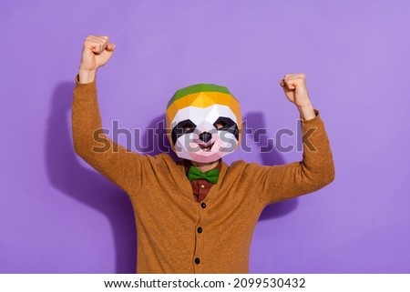 Photo of young man rejoice success fists hands triumph discount red panda isolated over violet color background