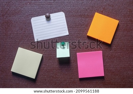 Colorful notes on dark brown board. Copy space