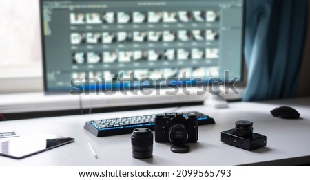 photo studio, photographer workplace table with retro style camera and desktop editing computer 