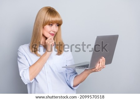 Photo of charming dreamy woman wear formal shirt reading modern device arm chin isolated grey color background