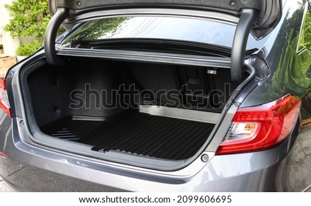 Closeup of empty rear cabin of gray sedan car. Preparing for luggage and suitcase loading. Royalty-Free Stock Photo #2099606695