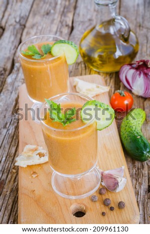 Cold summer vegetable soup a wooden background